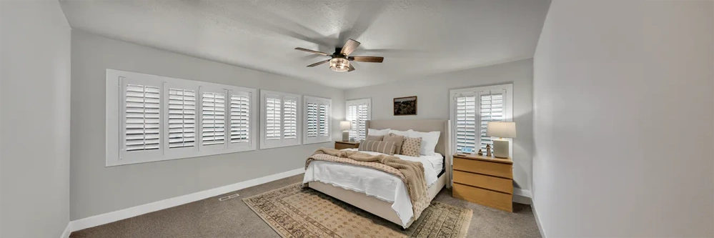 White Polywood shutters on five bedroom windows